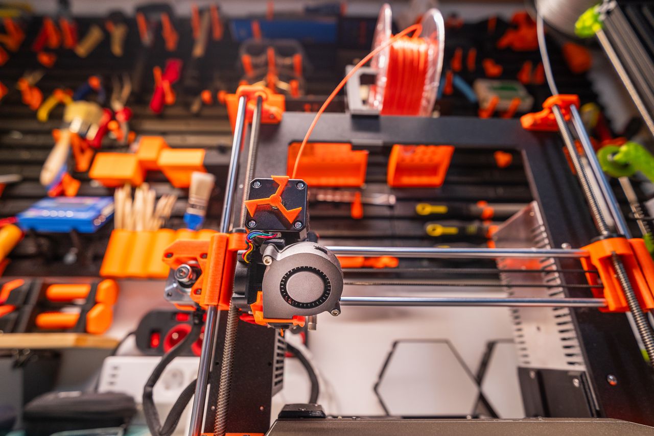 Crafting Captivating Headlines: Your awesome post title goes here Detailed view of a 3D printer with filament and tools in a workshop setting.